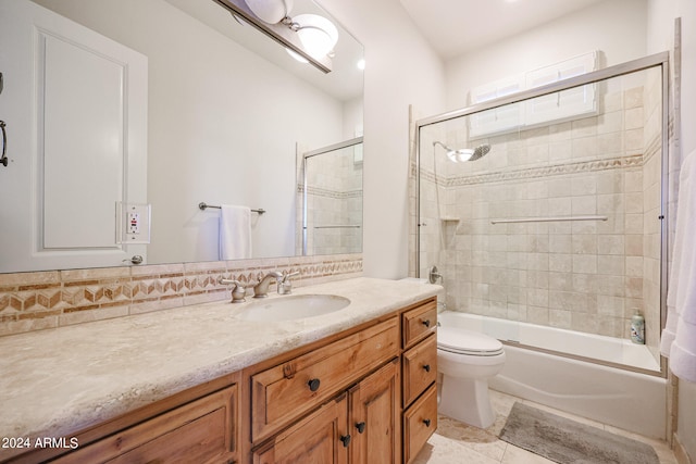 full bathroom with enclosed tub / shower combo, vanity, toilet, and tile patterned floors