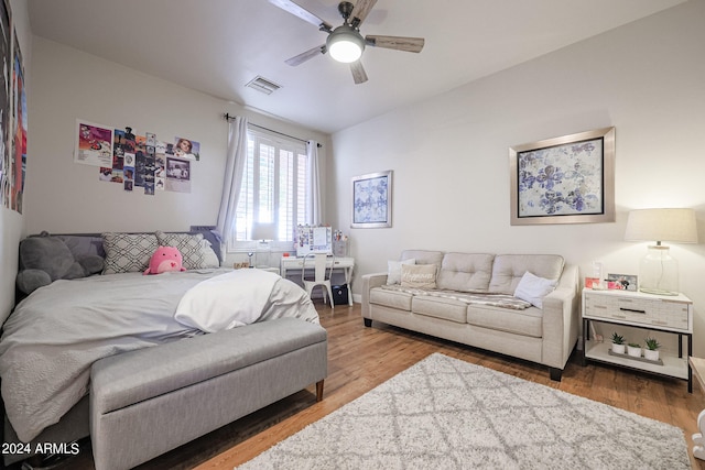 living room featuring ceiling fan and hardwood / wood-style flooring