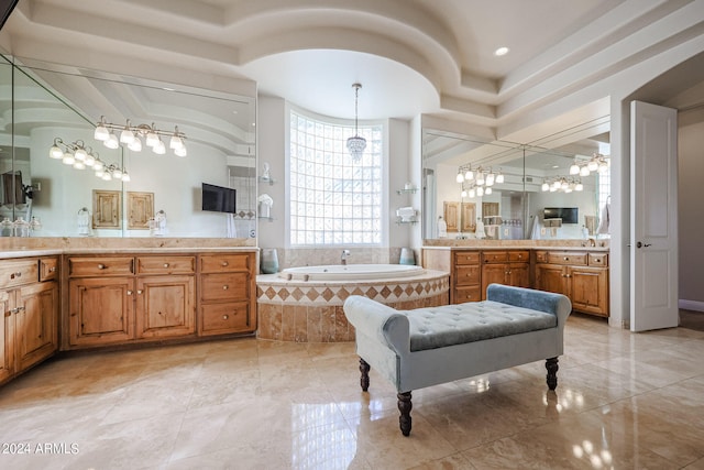 bathroom with vanity, separate shower and tub, and a notable chandelier