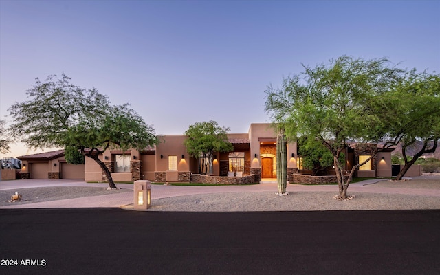 southwest-style home featuring a garage