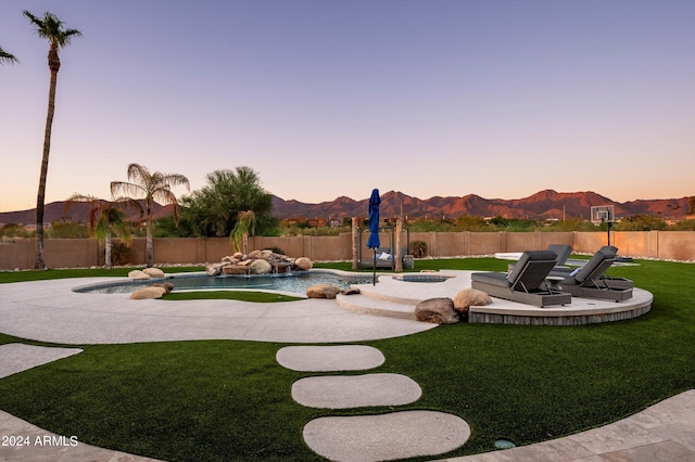 exterior space featuring a lawn and a mountain view