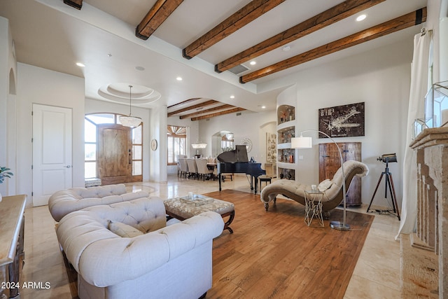 living room featuring beam ceiling and light hardwood / wood-style flooring