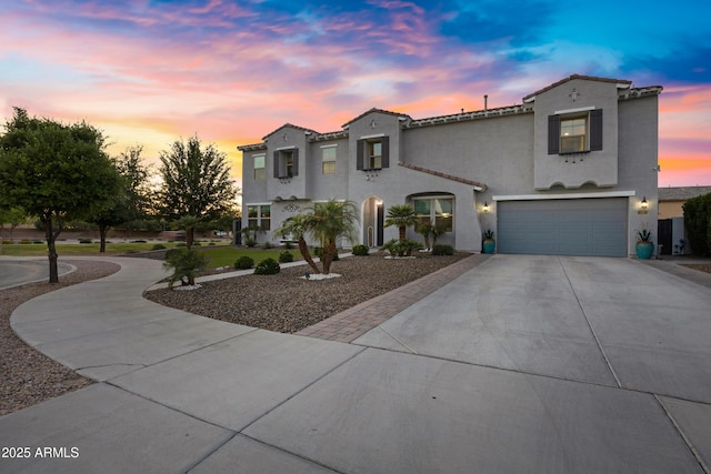 21328 E Misty Ln, Queen Creek, AZ 85142 - mediterranean / spanish home featuring a tile roof, stucco siding, a garage, and concrete driveway