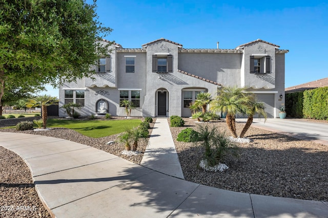 21328 E Misty Ln, Queen Creek, AZ 85142 - mediterranean / spanish-style home with a tiled roof, concrete driveway, a garage, and stucco siding