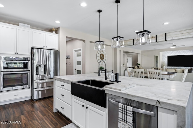21328 E Misty Ln, Queen Creek, AZ 85142 - kitchen with appliances with stainless steel finishes, recessed lighting, open floor plan, dark wood finished floors, and a sink