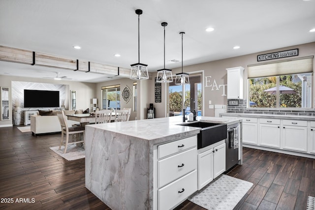 21328 E Misty Ln, Queen Creek, AZ 85142 - kitchen featuring light stone counters, a sink, dark wood finished floors, and recessed lighting