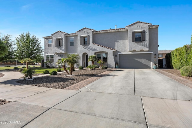 21328 E Misty Ln, Queen Creek, AZ 85142 - mediterranean / spanish home featuring a tiled roof, a garage, stucco siding, and driveway