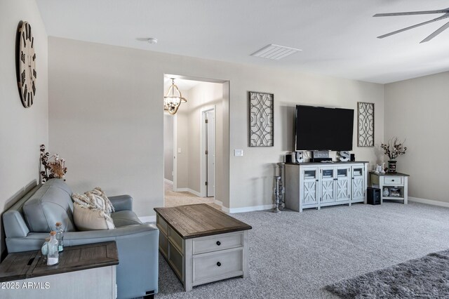 21328 E Misty Ln, Queen Creek, AZ 85142 - carpeted living room with ceiling fan with notable chandelier, baseboards, and visible vents