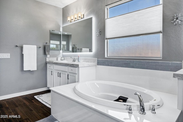 21328 E Misty Ln, Queen Creek, AZ 85142 - bathroom with a bath, vanity, wood finished floors, and baseboards