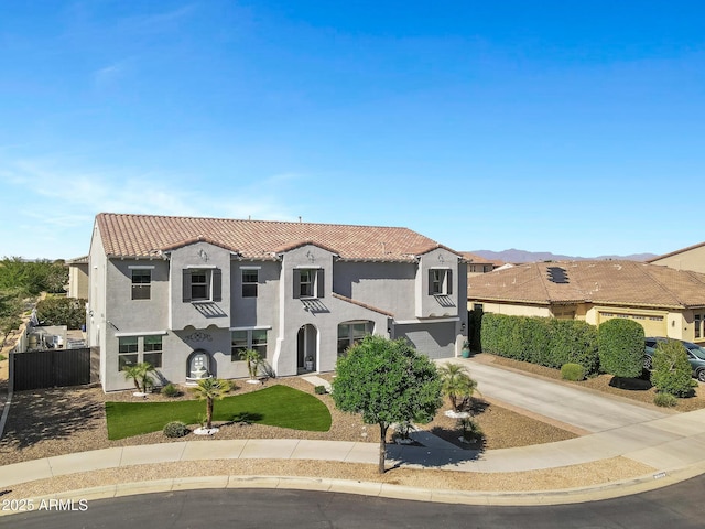 21328 E Misty Ln, Queen Creek, AZ 85142 - mediterranean / spanish-style home featuring a tiled roof, stucco siding, a front lawn, an attached garage, and driveway