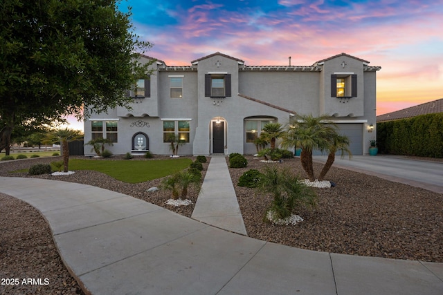 21328 E Misty Ln, Queen Creek, AZ 85142 - mediterranean / spanish home with concrete driveway, a tiled roof, a garage, and stucco siding