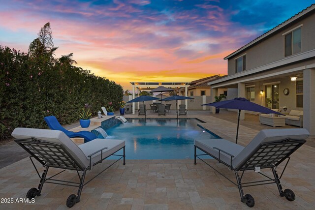 21328 E Misty Ln, Queen Creek, AZ 85142 - pool at dusk with a patio area, an outdoor living space, and an outdoor pool