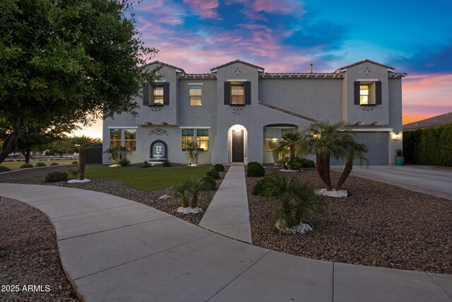 21328 E Misty Ln, Queen Creek, AZ 85142 - mediterranean / spanish house with concrete driveway, stucco siding, a tiled roof, and an attached garage