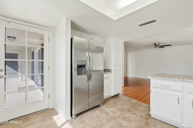 kitchen featuring stainless steel fridge with ice dispenser, visible vents, white cabinetry, and a ceiling fan