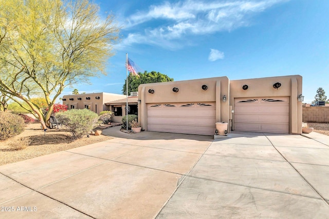 pueblo revival-style home with a garage