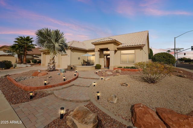 mediterranean / spanish-style house featuring a garage