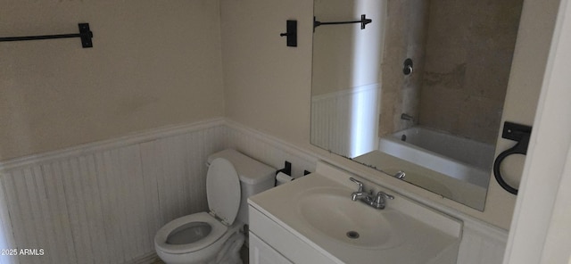 full bathroom with a bathtub, a shower, toilet, wainscoting, and vanity