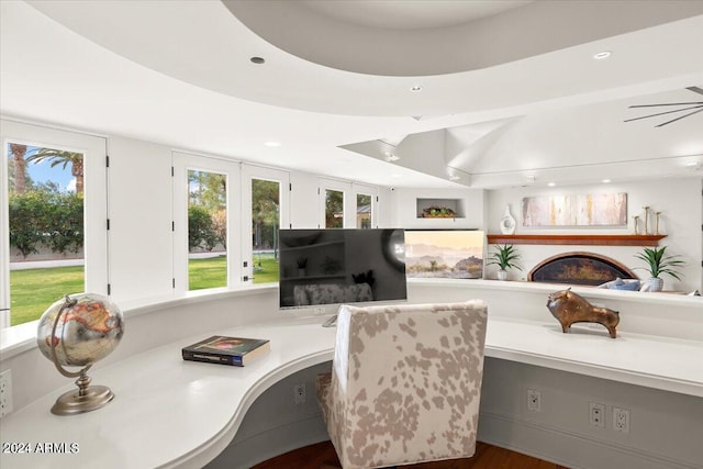 home office with built in desk, a healthy amount of sunlight, french doors, and wood-type flooring