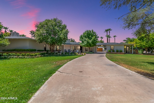 single story home with a lawn