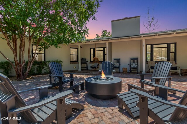 patio terrace at dusk with an outdoor fire pit