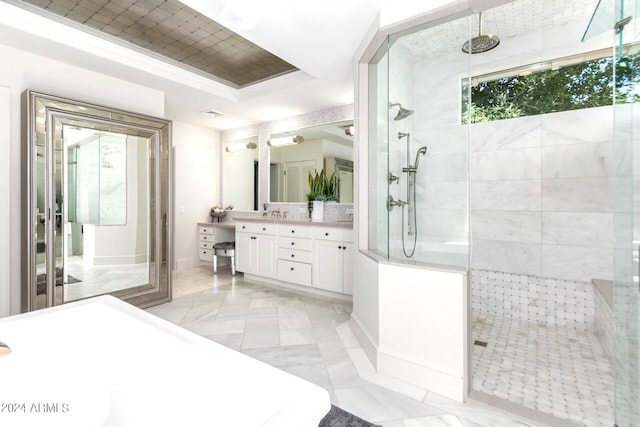 bathroom featuring vanity, plenty of natural light, tile patterned floors, a tile shower, and a tray ceiling