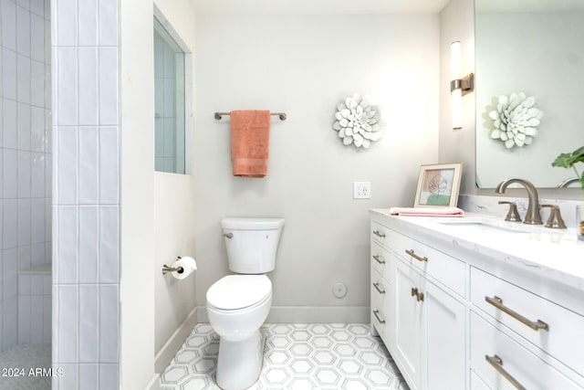 bathroom with tile patterned flooring, vanity, and toilet