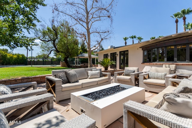 view of patio / terrace with an outdoor living space with a fire pit