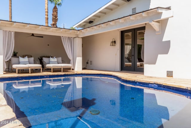 view of swimming pool featuring a patio area and french doors