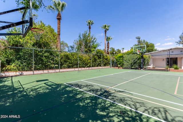 view of tennis court featuring basketball hoop