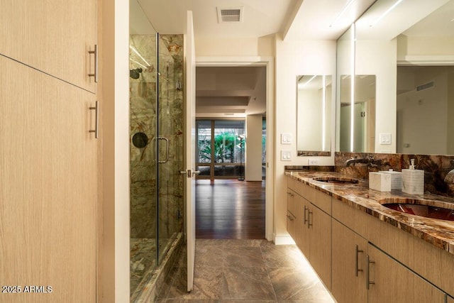 bathroom featuring walk in shower and vanity