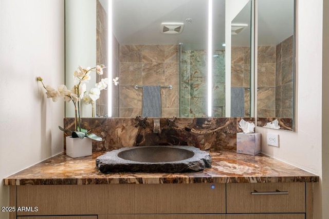 bathroom featuring tasteful backsplash and vanity