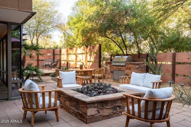 view of patio featuring area for grilling, grilling area, and an outdoor fire pit