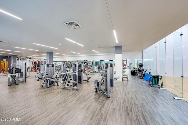 workout area with light hardwood / wood-style floors