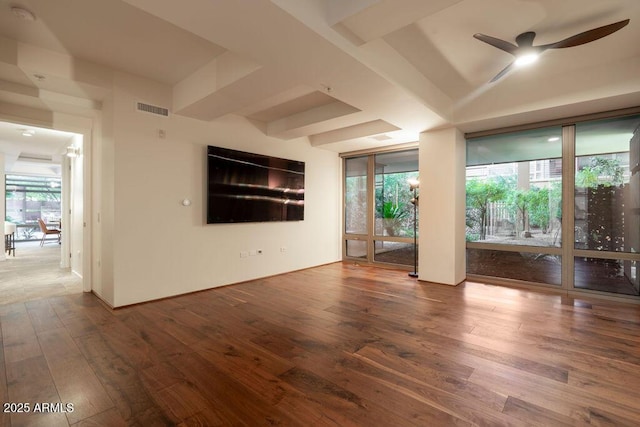 spare room with hardwood / wood-style flooring, a wealth of natural light, and ceiling fan