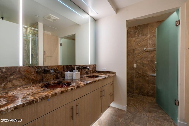 bathroom featuring vanity and a shower with door