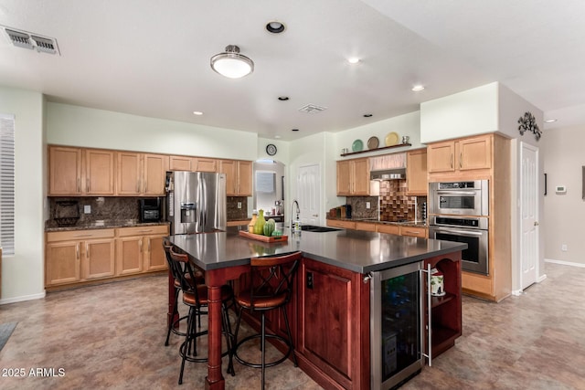 818 E Hiddenview Dr, Phoenix, AZ 85048 - kitchen featuring stainless steel appliances, wine cooler, dark countertops, a sink, and decorative backsplash