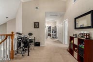 818 E Hiddenview Dr, Phoenix, AZ 85048 - corridor with lofted ceiling and carpet