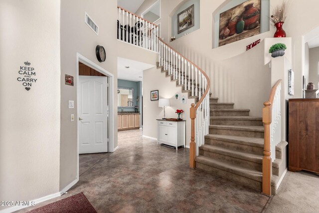 818 E Hiddenview Dr, Phoenix, AZ 85048 - staircase featuring baseboards, concrete floors, and a towering ceiling