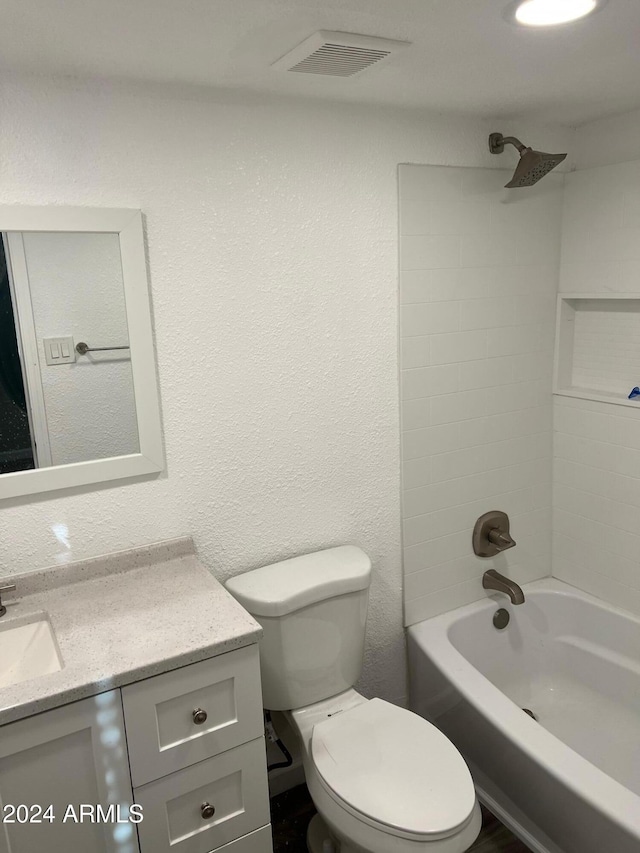 full bathroom with washtub / shower combination, vanity, and toilet