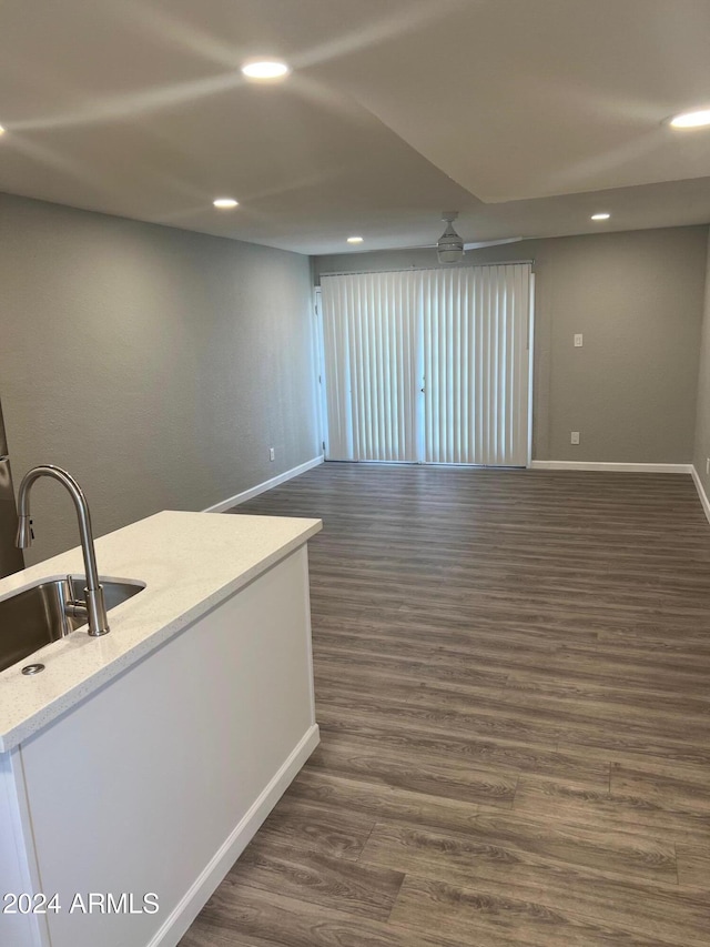 interior space with dark hardwood / wood-style floors, ceiling fan, and sink