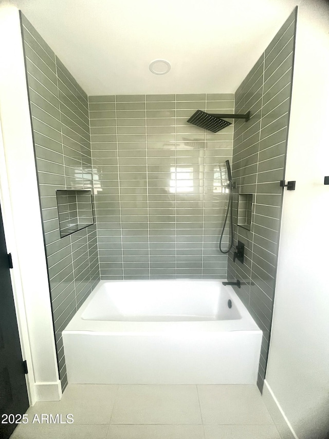 bathroom featuring bathtub / shower combination, tile patterned flooring, and baseboards