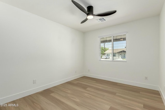 unfurnished room featuring light wood-style flooring, ceiling fan, baseboards, and visible vents