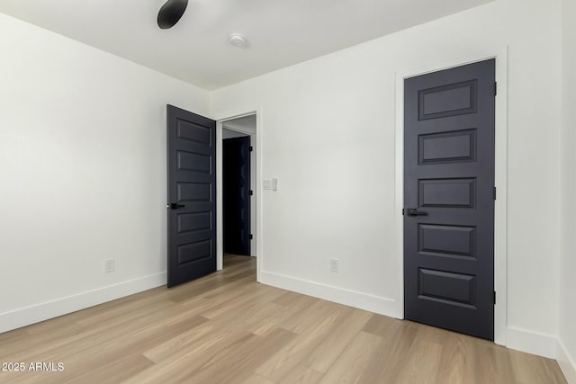 spare room with light wood-style flooring and baseboards