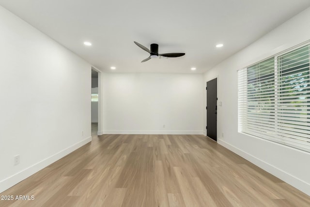 spare room with ceiling fan, light wood finished floors, recessed lighting, and baseboards