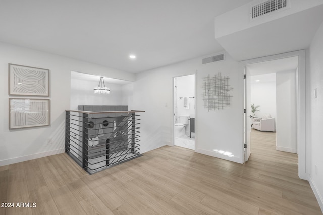 interior space featuring hardwood / wood-style floors and a notable chandelier