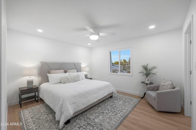 bedroom with ceiling fan and light hardwood / wood-style flooring