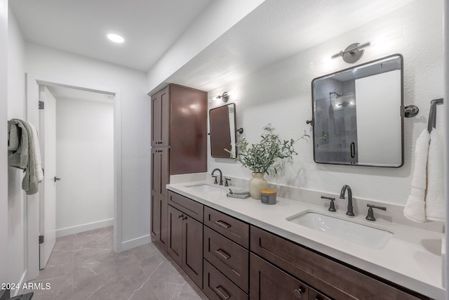 bathroom featuring an enclosed shower and vanity