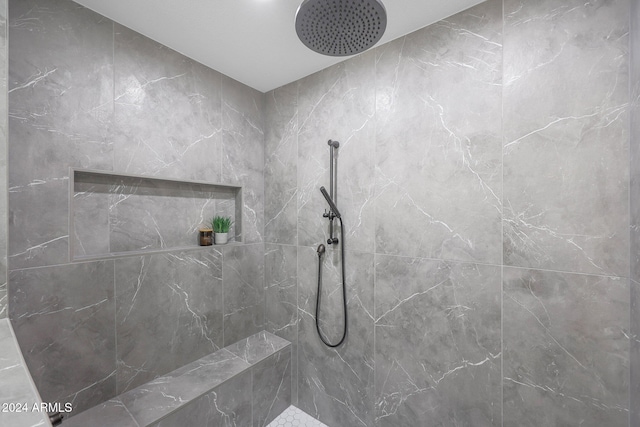 bathroom with a tile shower