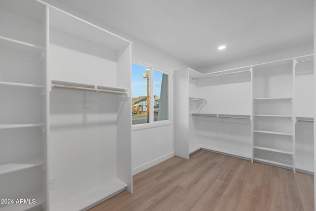 walk in closet featuring light hardwood / wood-style flooring