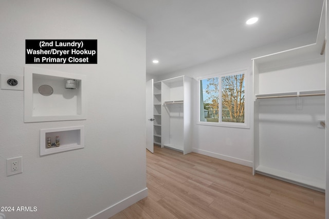 walk in closet with light wood-type flooring